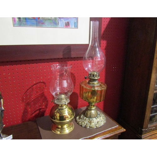 4039 - A Victorian brass based oil lamp with another later example (2)