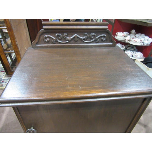 4051 - A small single door cupboard with carved upstand, 56cm total hight with gallery back