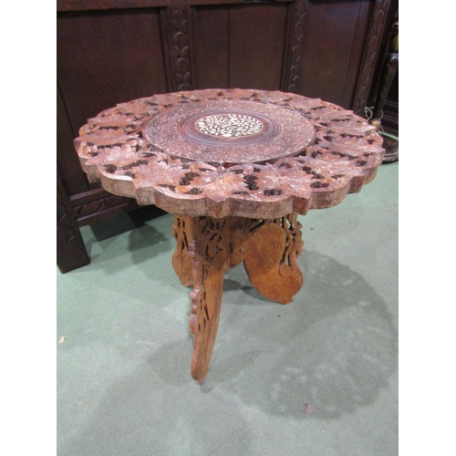 4017 - An Indian foliate carved folding occasional table, bone inlay to top, 46cm tall x 45cm diameter