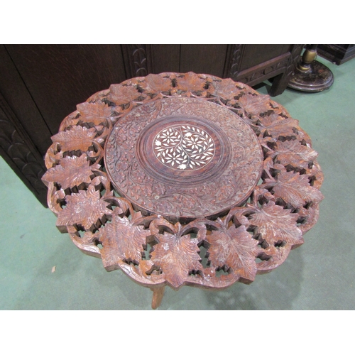 4017 - An Indian foliate carved folding occasional table, bone inlay to top, 46cm tall x 45cm diameter