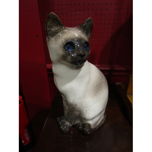 4029 - A Winstanley seated cat, white and grey with blue glass eyes, 33cm tall