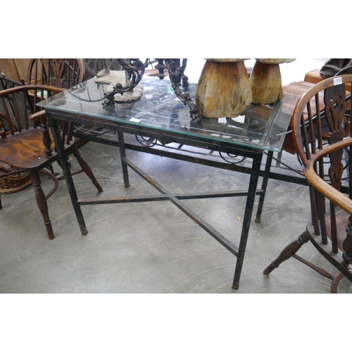 2038 - A cast garden table with glass top