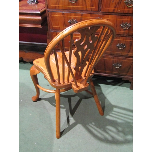 2048 - A pair of hoop back Windsor chairs with cabriole fore legs united by a crinoline stretcher