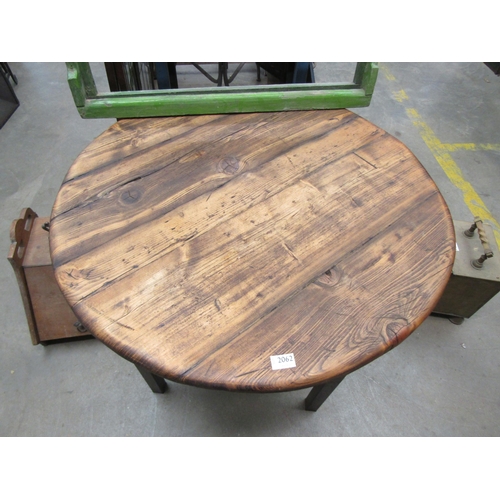 2044 - A rustic metal based circular pine topped table