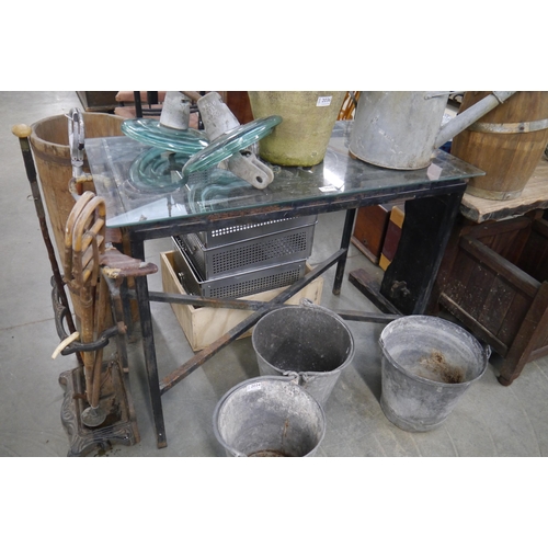 2038 - A cast garden table with glass top