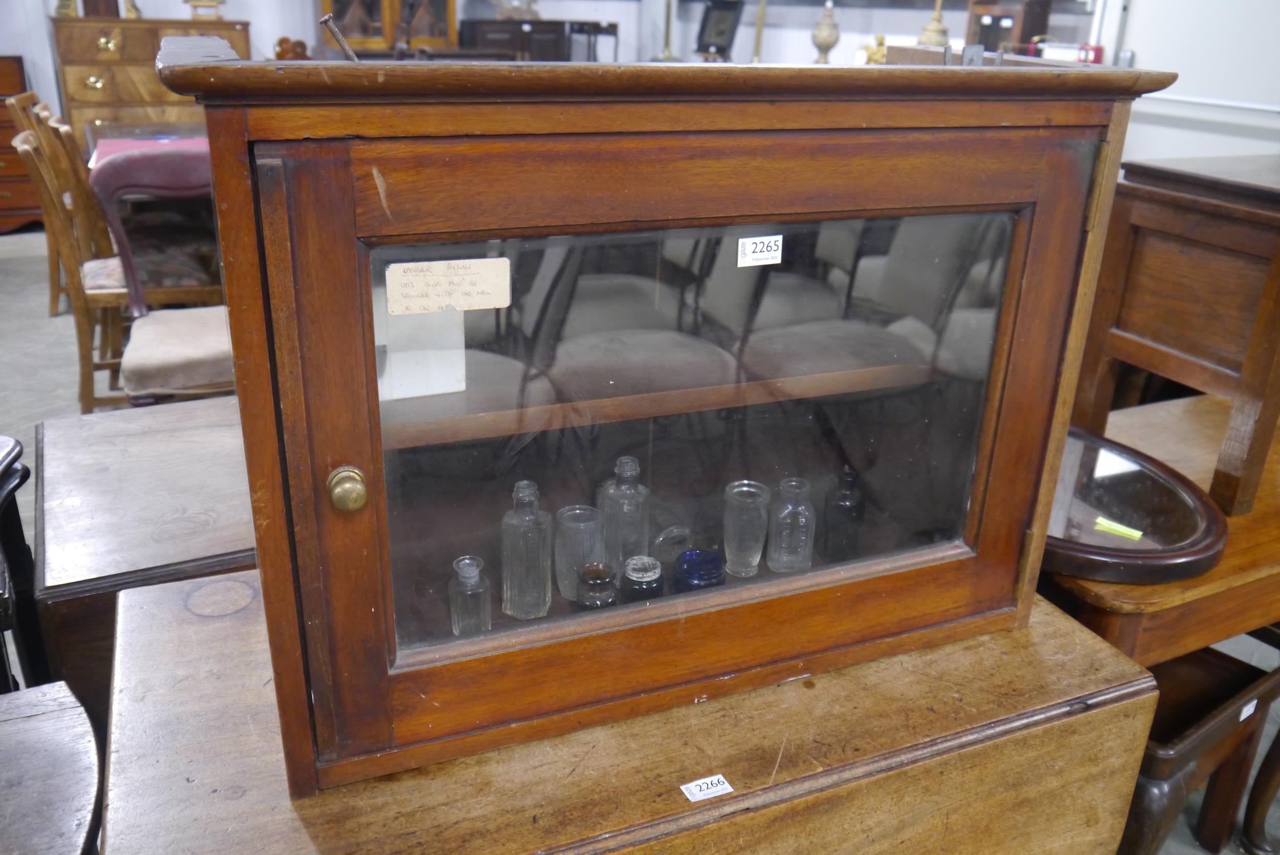A Victorian mahogany medicine/poison cabinet with bottles