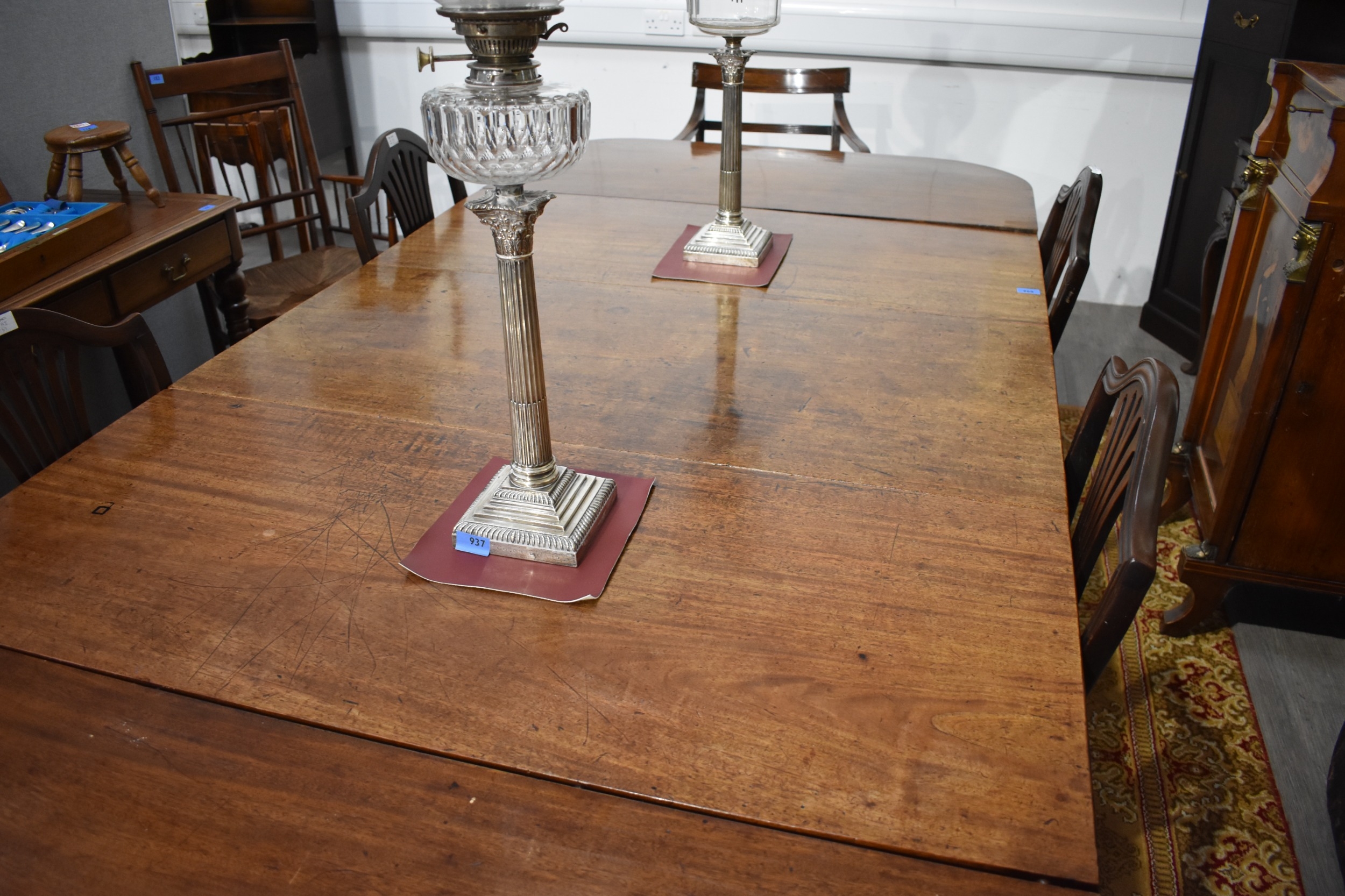 A mahogany dining table, un-extended the table forms a drop-flap table ...