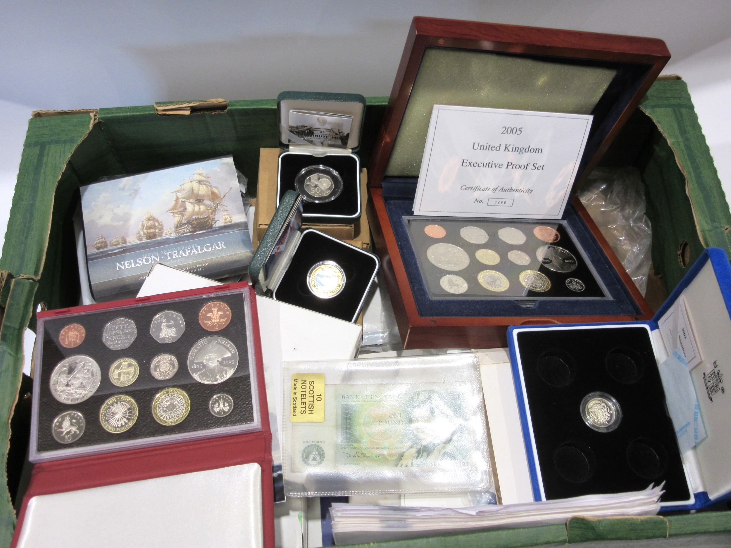 A collection of Royal Mint cased uncirculated coin sets and single ...