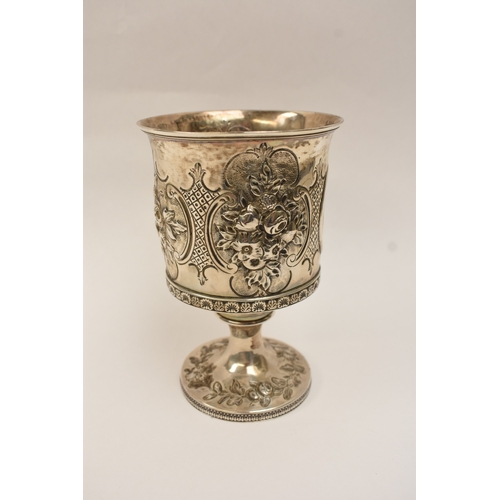 6006 - A Georgian silver wine goblet with embossed floral cartouches, decorative border, central monogramme... 