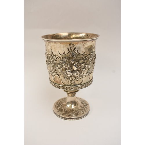 6006 - A Georgian silver wine goblet with embossed floral cartouches, decorative border, central monogramme... 