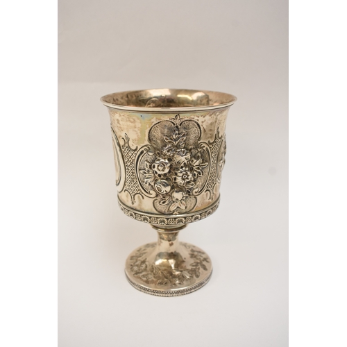 6006 - A Georgian silver wine goblet with embossed floral cartouches, decorative border, central monogramme... 