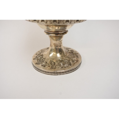 6006 - A Georgian silver wine goblet with embossed floral cartouches, decorative border, central monogramme... 