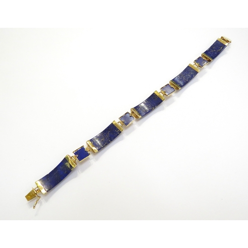 7505 - A 14ct gold bracelet with five curved panels of Lapis Lazuli, 19.5cm long, 15.7g