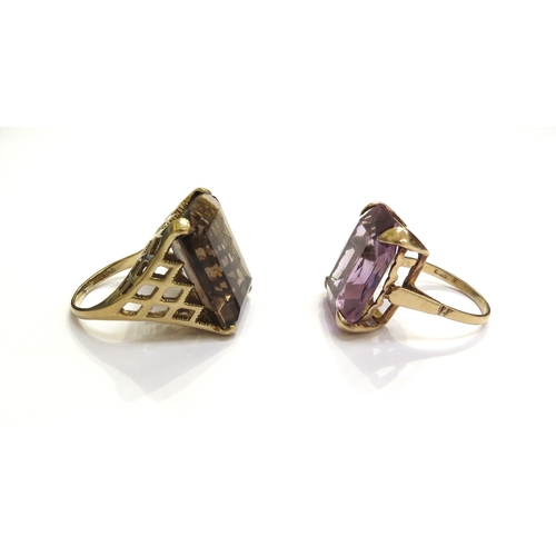 7432 - A 9ct gold ring set with a large rectangular smoky quartz, size N and another with amethyst coloured... 