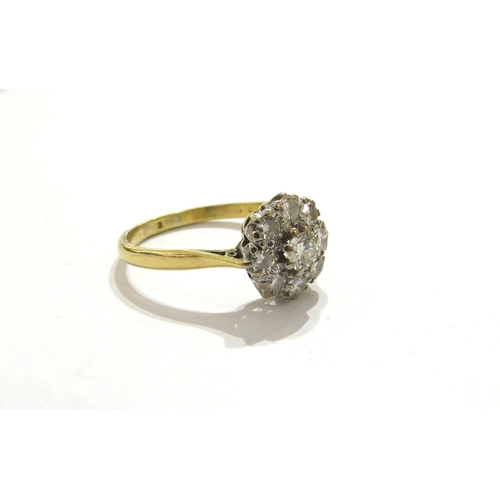7037 - An 18ct gold diamond daisy cluster ring, marks rubbed. Size V, 3.8g