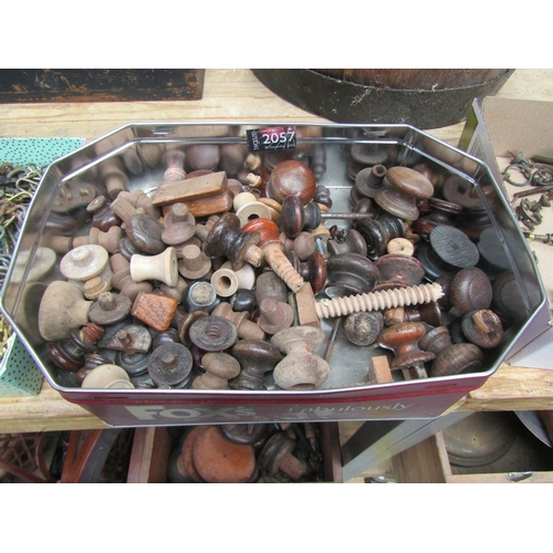2057 - A tin of Victorian and later wooden knobs