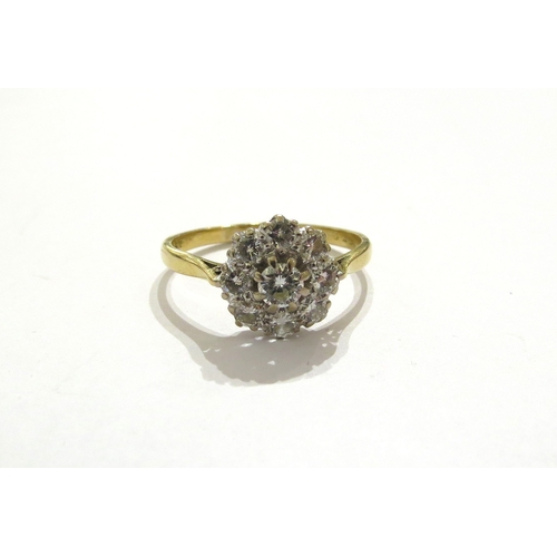 7037 - An 18ct gold diamond daisy cluster ring, marks rubbed. Size V, 3.8g