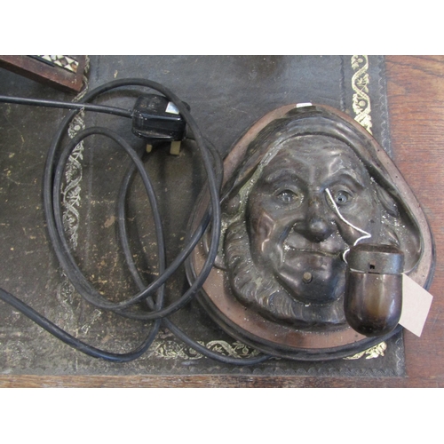 2002 - A brass fisherman's head wall light with pipe and glass eyes