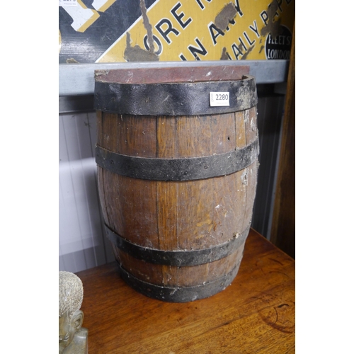 2043 - An oak half barrel stick stand