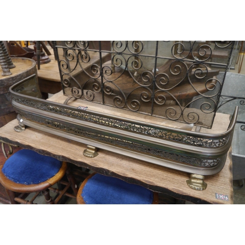 2049 - A Victorian brass fender and fire irons