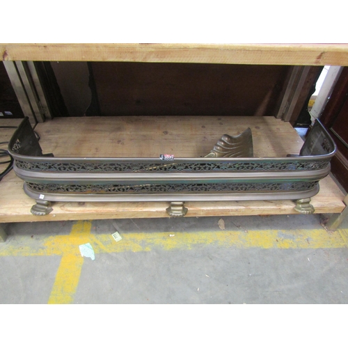 2049 - A Victorian brass fender and fire irons