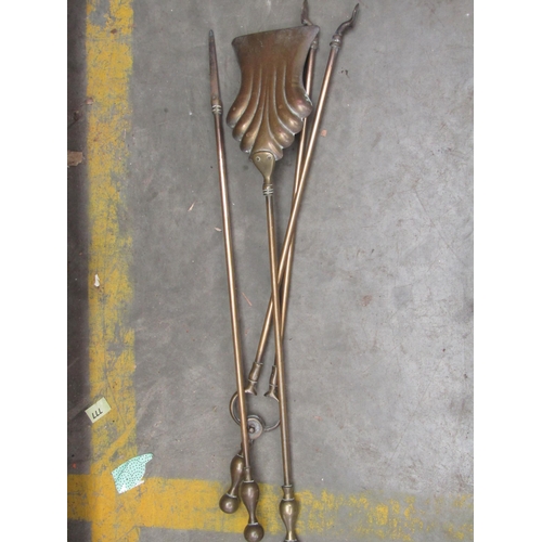 2049 - A Victorian brass fender and fire irons