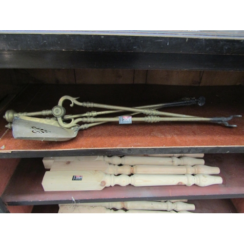 2061 - Brass fire tools; two pairs on tongs and a shovel