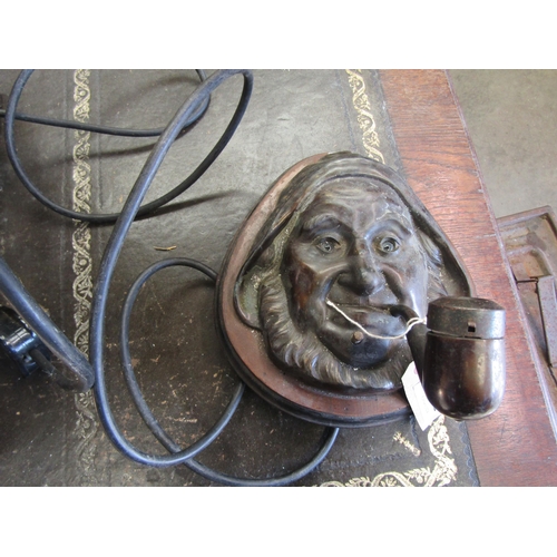 2002 - A brass fisherman's head wall light with pipe and glass eyes