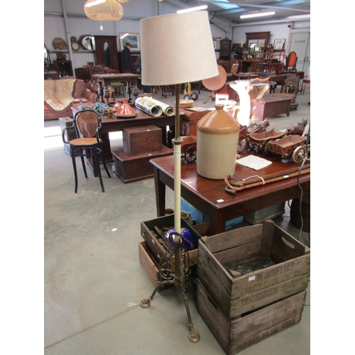 2030 - A brass standard lamp with paw feet