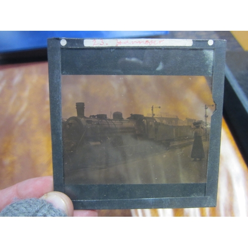 7041 - A tin containing approx. 50 glass negative magic lantern slides, all railway related including steam... 