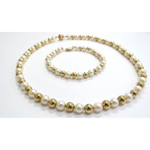 7023 - A pearl and gold bead necklace, 40cm with a matching bracelet, 17.5cm long, both marked 14k, 20g tot... 