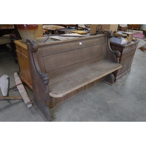 2001 - An Edwardian oak pew with vine leaf carved ends 137cm wide