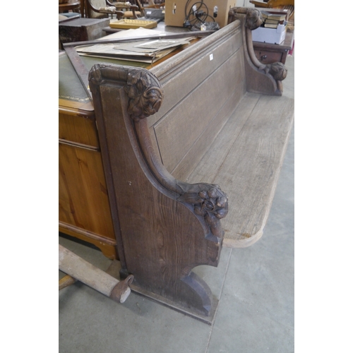 2001 - An Edwardian oak pew with vine leaf carved ends 137cm wide