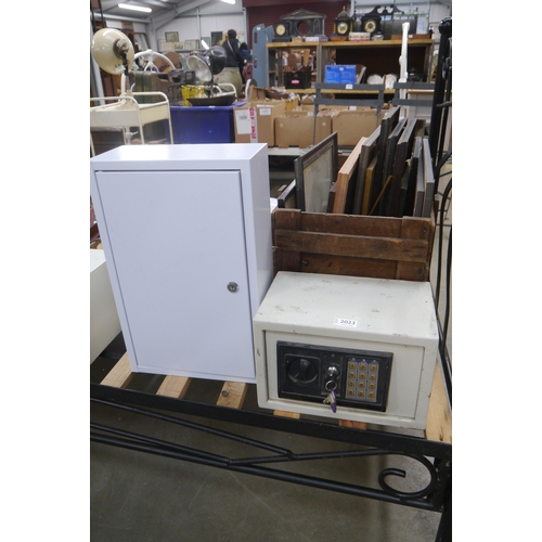 2023 - A small safe box and key and a metal wall cabinet,
 with no key