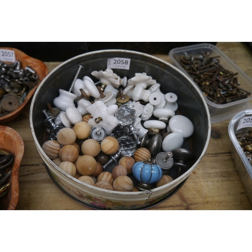 2058 - A tin of ceramic knobs