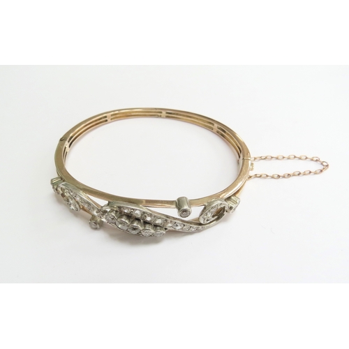 7059 - A diamond set hinged bangle with 35 various sized rose cut diamonds, unmarked, 6cm x 5cm, 16g