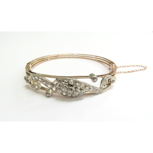 7059 - A diamond set hinged bangle with 35 various sized rose cut diamonds, unmarked, 6cm x 5cm, 16g