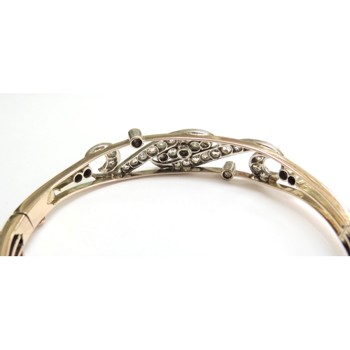 7059 - A diamond set hinged bangle with 35 various sized rose cut diamonds, unmarked, 6cm x 5cm, 16g