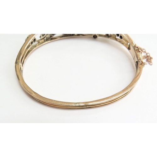 7059 - A diamond set hinged bangle with 35 various sized rose cut diamonds, unmarked, 6cm x 5cm, 16g