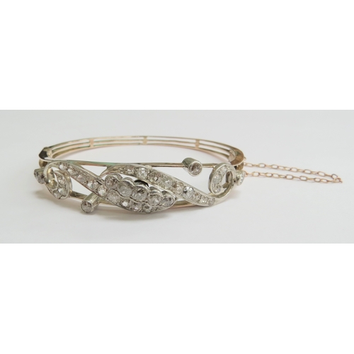 7059 - A diamond set hinged bangle with 35 various sized rose cut diamonds, unmarked, 6cm x 5cm, 16g