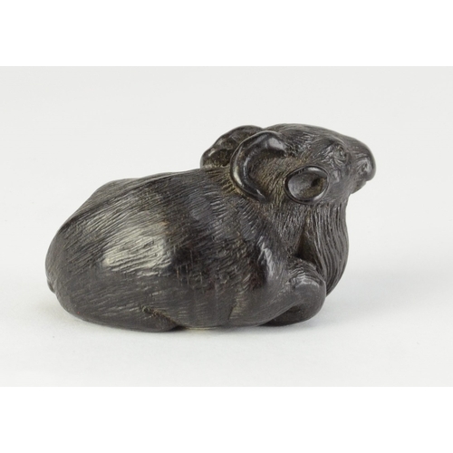 9056 - MINKO a carved persimmon wood netsuke in the form of a recumbent goat, signed Minko to base

4cm wid... 