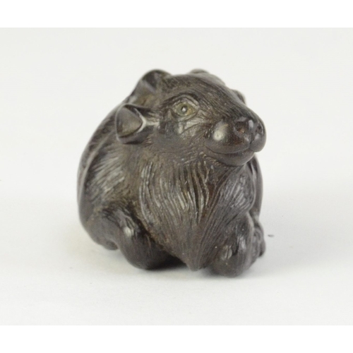 9056 - MINKO a carved persimmon wood netsuke in the form of a recumbent goat, signed Minko to base

4cm wid... 