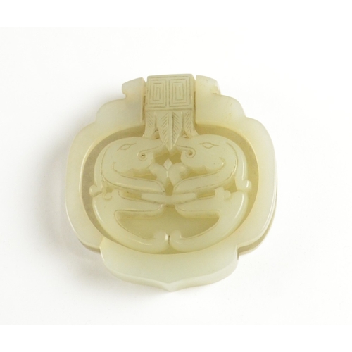 9021 - A Chinese pale celadon belt fitting in the form of two dragons to the front, the reverse inscribed w... 