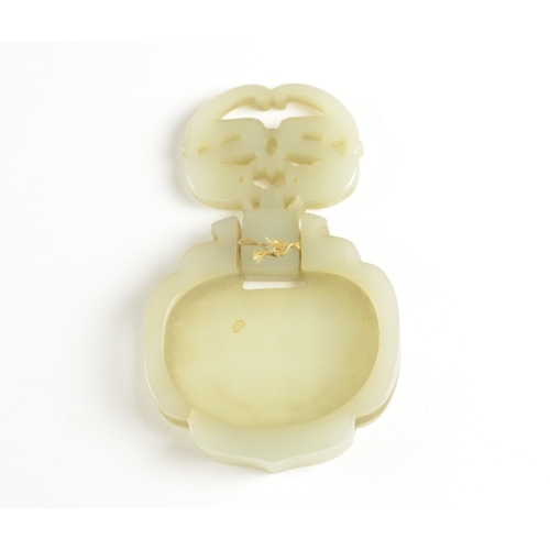 9021 - A Chinese pale celadon belt fitting in the form of two dragons to the front, the reverse inscribed w... 