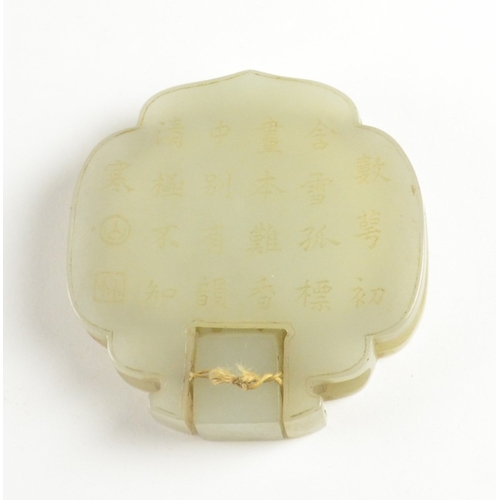 9021 - A Chinese pale celadon belt fitting in the form of two dragons to the front, the reverse inscribed w... 