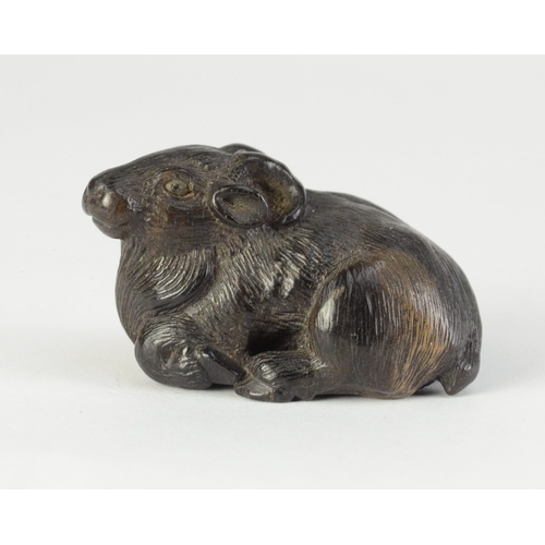 9056 - MINKO a carved persimmon wood netsuke in the form of a recumbent goat, signed Minko to base

4cm wid... 