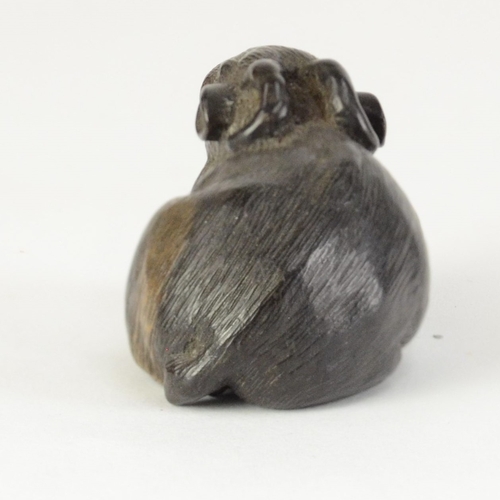 9056 - MINKO a carved persimmon wood netsuke in the form of a recumbent goat, signed Minko to base

4cm wid... 