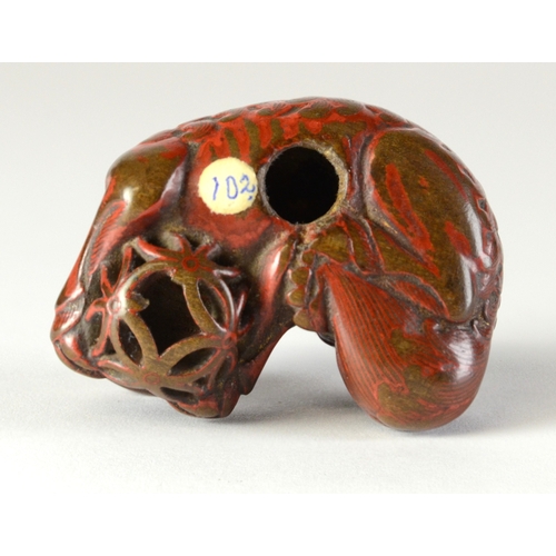 9048 - A lacquered negoro netsuke of a shishi with baby on back, holding a ball in front paws

4cm wide x 3... 