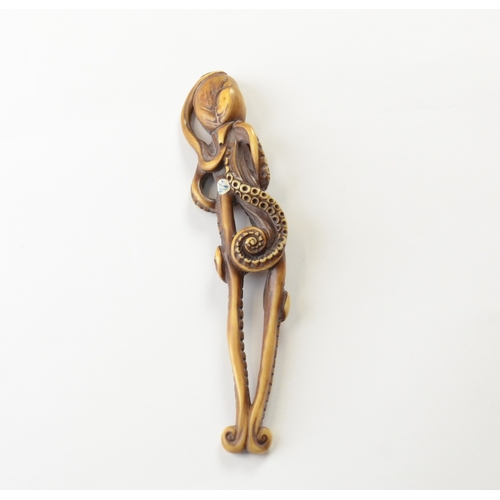 9039 - A tall ivory netsuke of an anthropomorphic octopus standing on two tentacles, posed as though human ... 