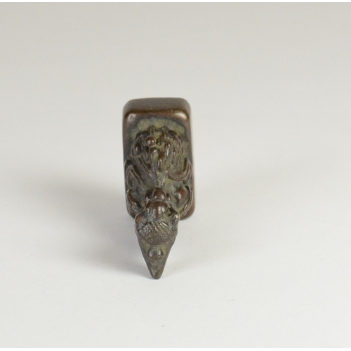 9032 - A Chinese bronze seal in the form of a mythical creature

5cm high, 3.2cm wide and 2cm deep

Provena... 